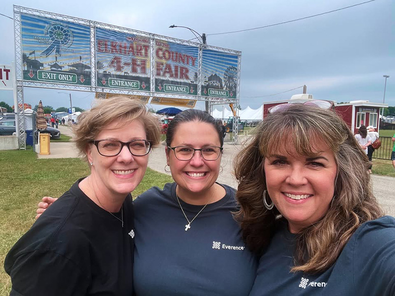 Three Everence employees pose in front of the Elkhart County 4H Fair