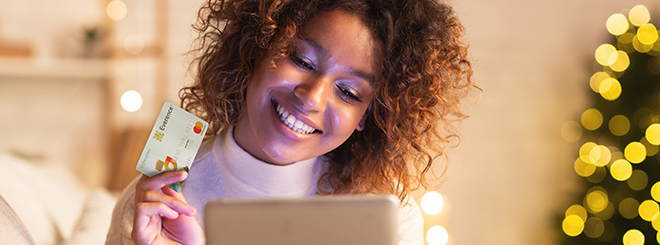 Woman holding MyNeighbor credit card