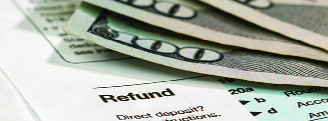 Dollar bills & tax return form