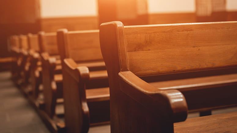 Pews in a row lit up by warm sunlight