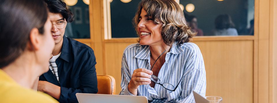 Smiling team members discussing ideas in a church meeting atmosphere