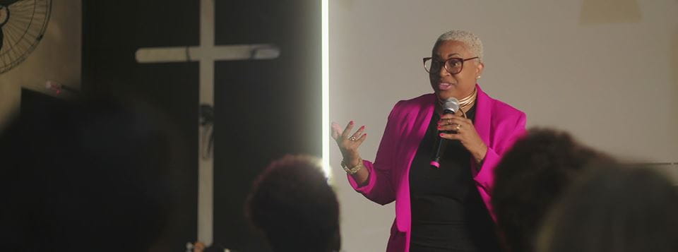 Woman preaching in front of congregation