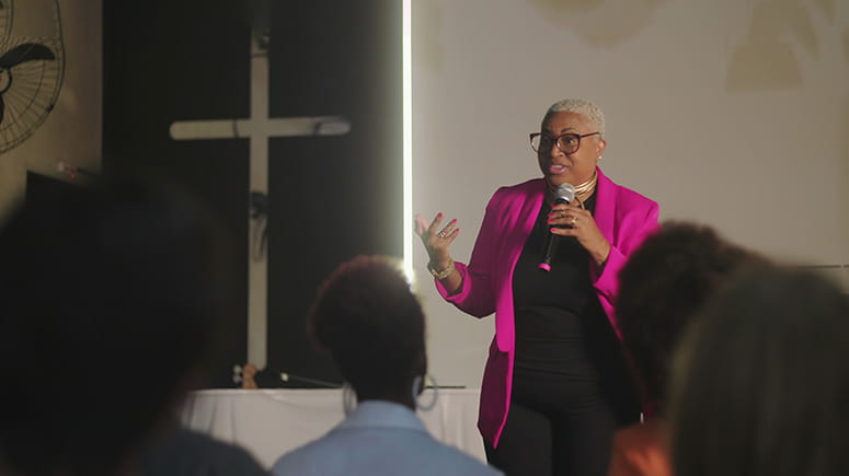 Woman preaching in front of congregation