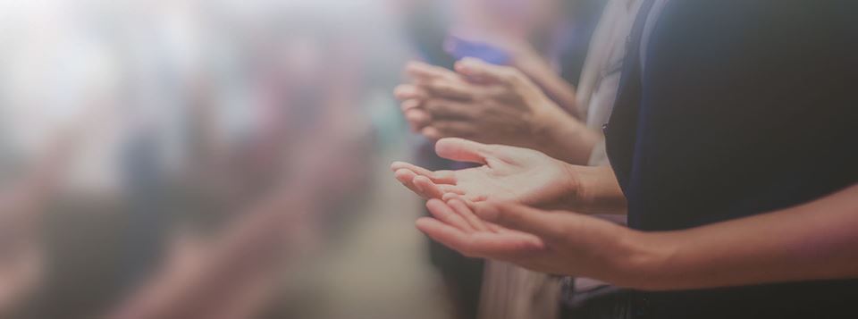 Hands of church goers lifted in prayer
