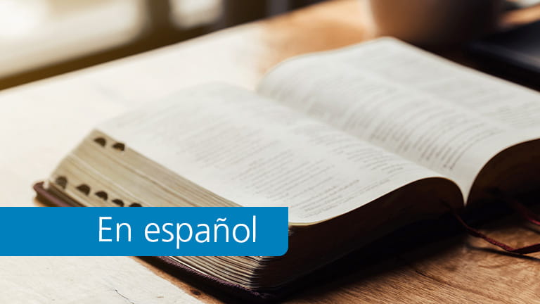 Open bible with a cup of coffee for morning devotion on wooden table