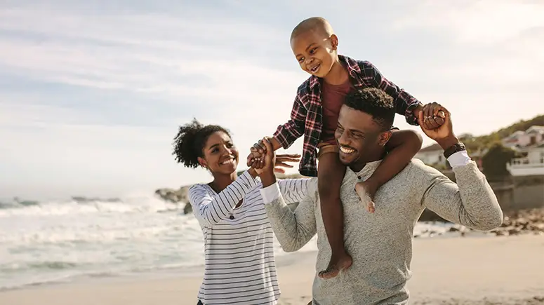 Family playing together on beach.