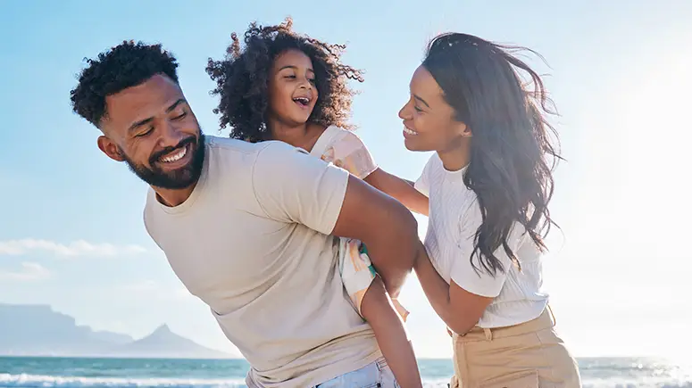 Family playing together on the beach.